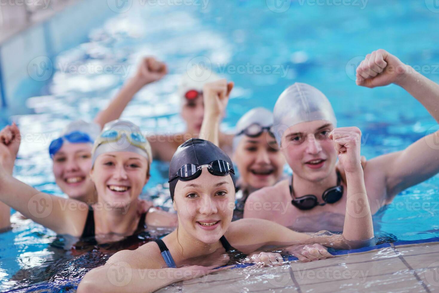 happy teen group  at swimming pool photo