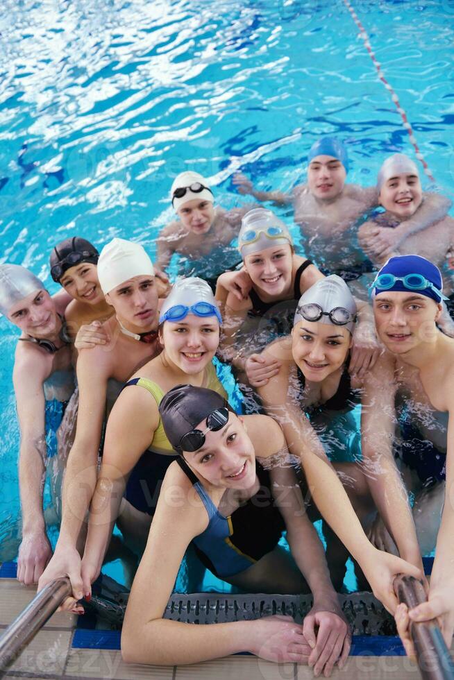 happy teen group  at swimming pool photo