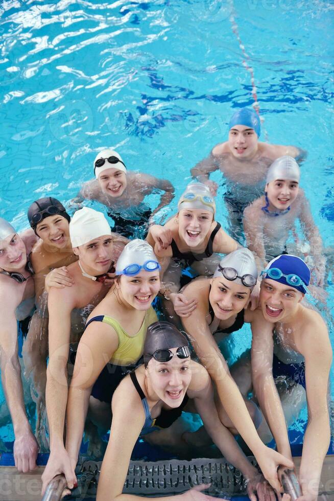 happy teen group  at swimming pool photo