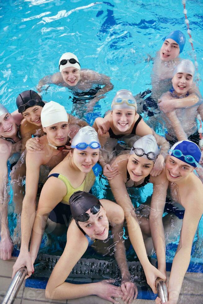 happy teen group  at swimming pool photo