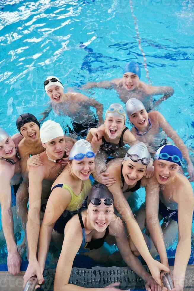 happy teen group  at swimming pool photo