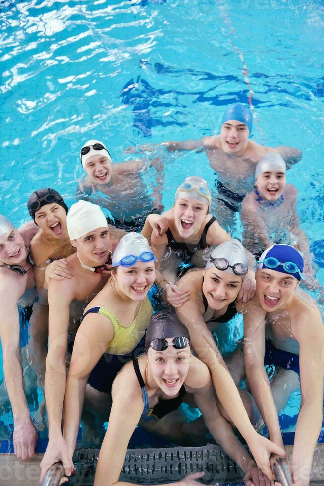 happy teen group  at swimming pool photo