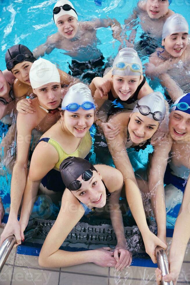 happy teen group  at swimming pool photo