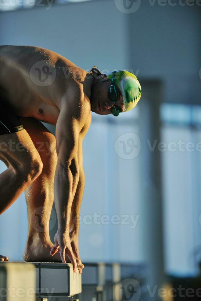 young swimmmer on swimming start photo