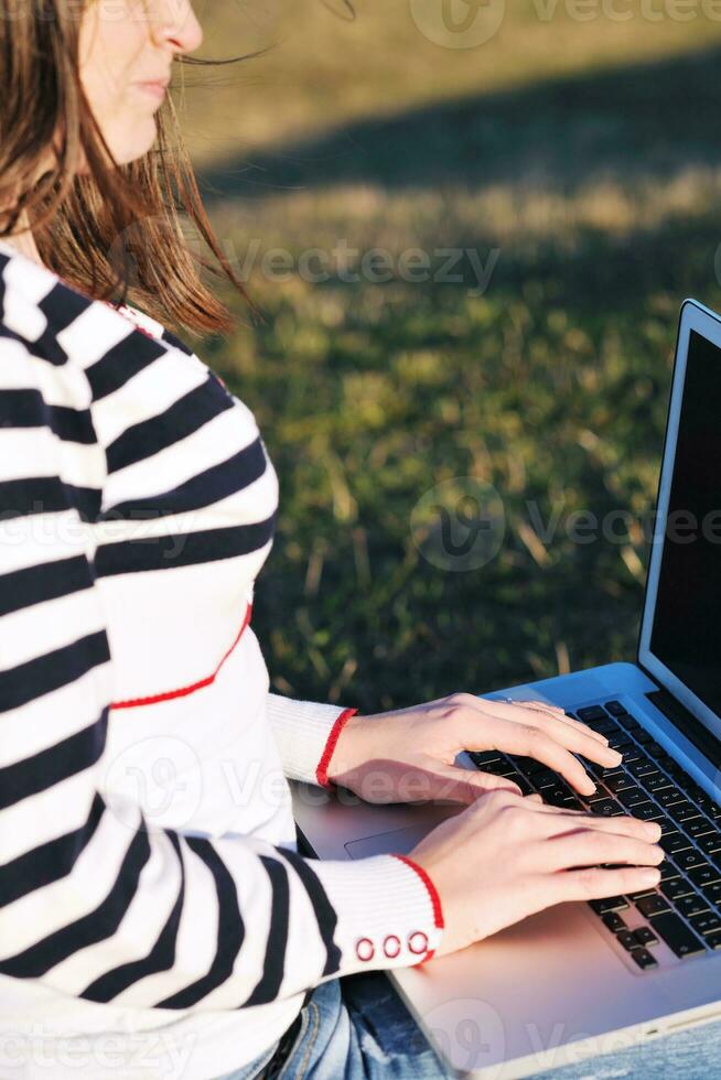 young teen girl work on laptop outdoor photo