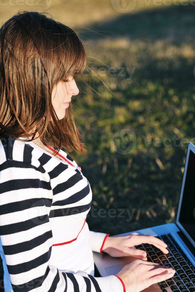 young teen girl work on laptop outdoor photo