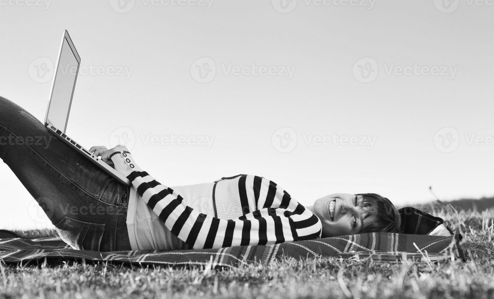 young teen girl work on laptop outdoor photo