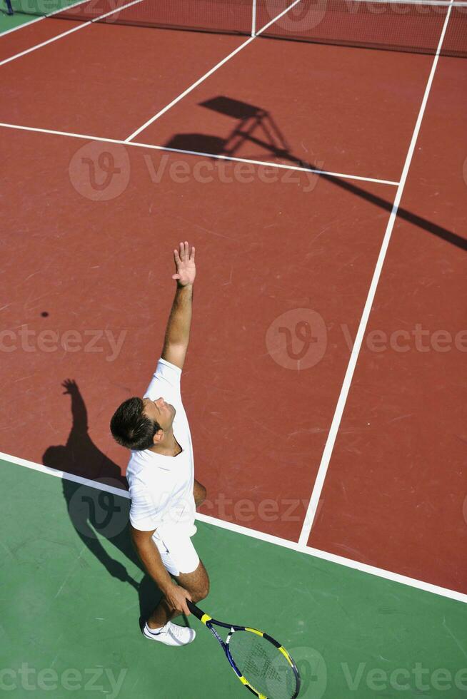 young man play tennis outdoor photo