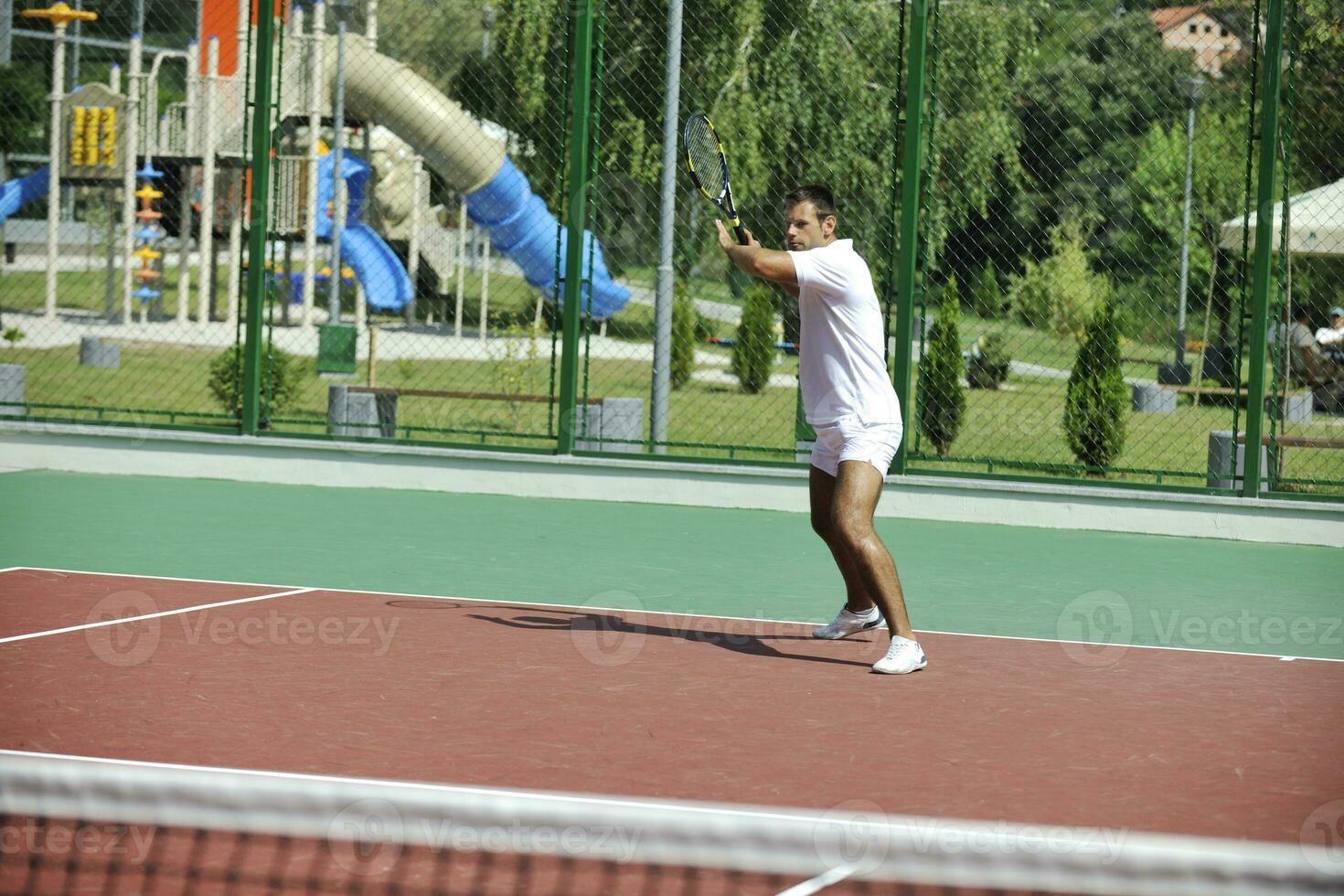 young man play tennis outdoor photo