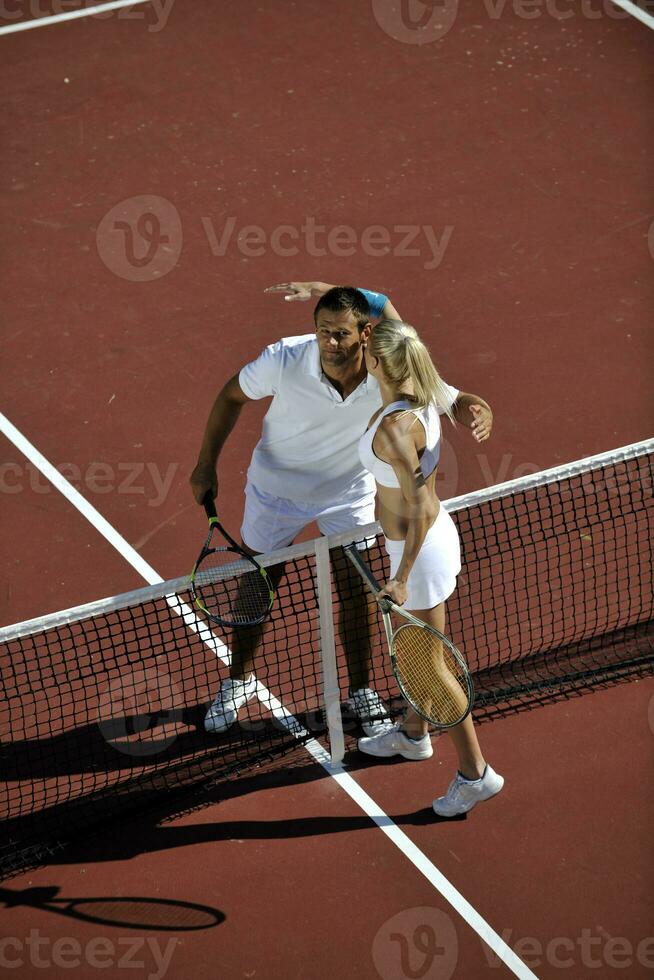 happy young couple play tennis game outdoor photo