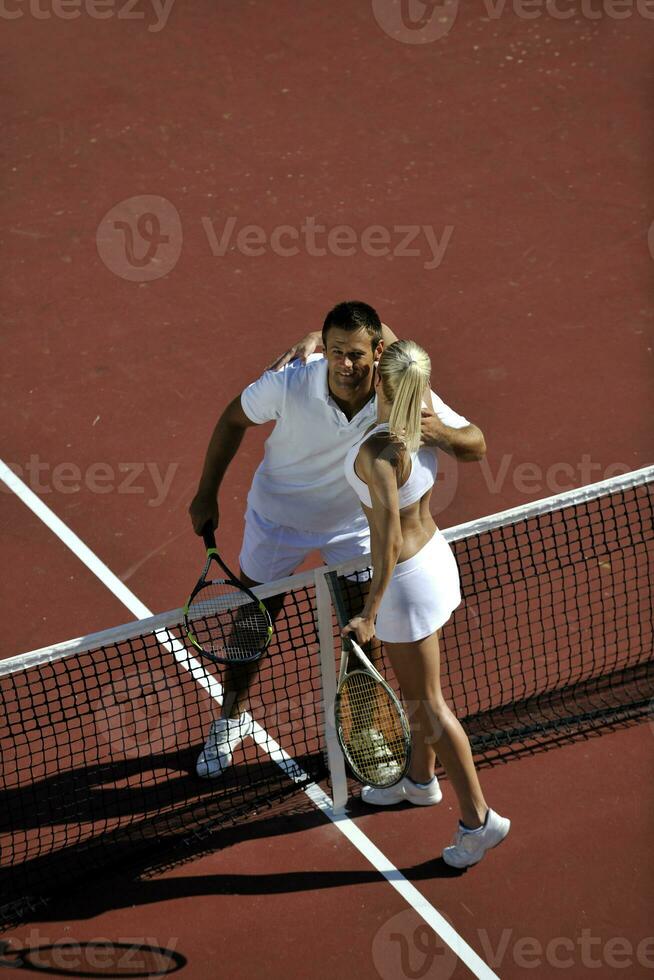 happy young couple play tennis game outdoor photo