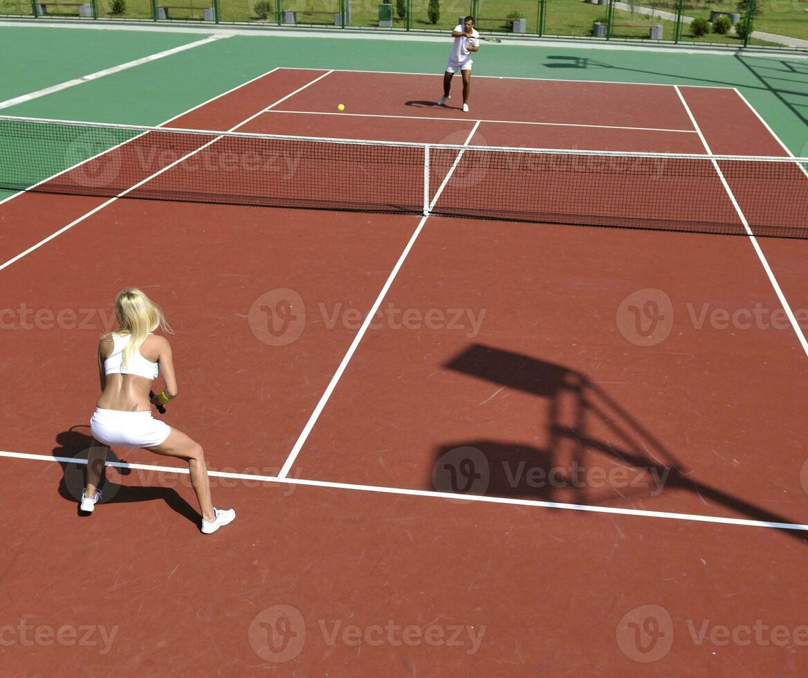 young woman play tennis game outdoor photo