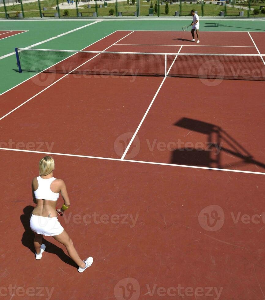 young woman play tennis game outdoor photo