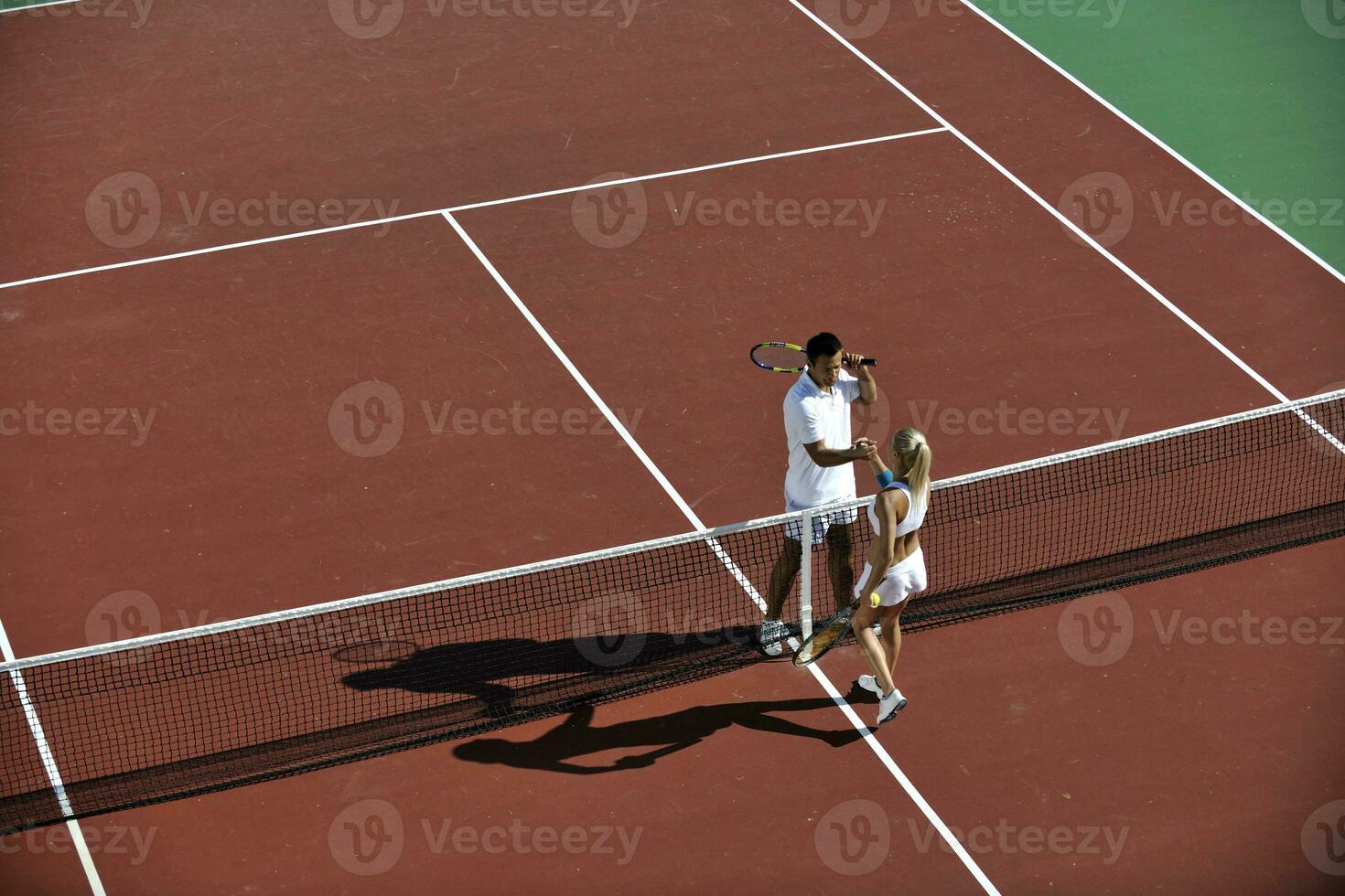 happy young couple play tennis game outdoor photo