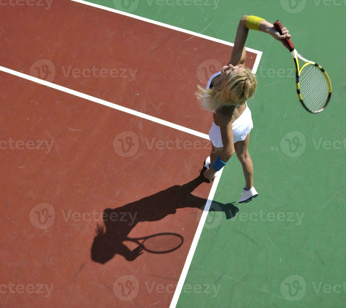 young woman play tennis game outdoor photo