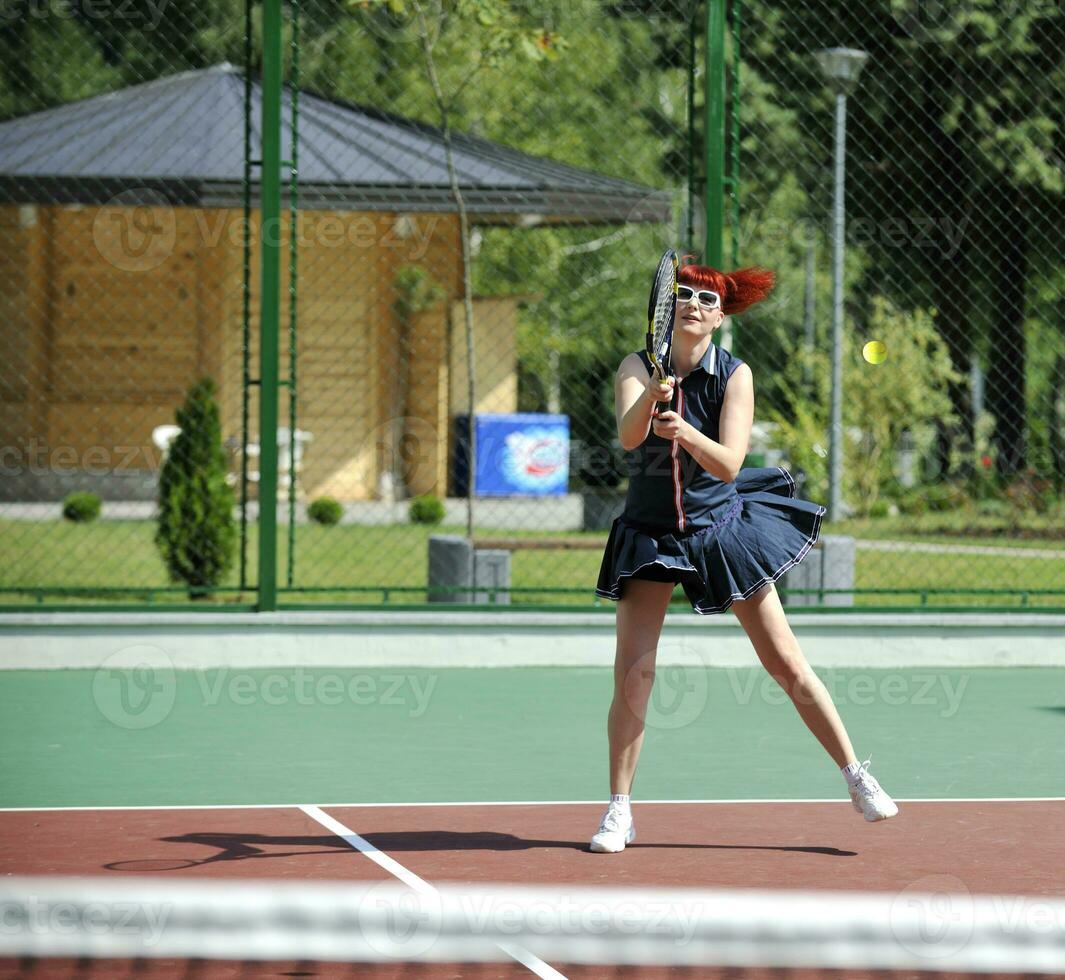 young woman play tennis game outdoor photo