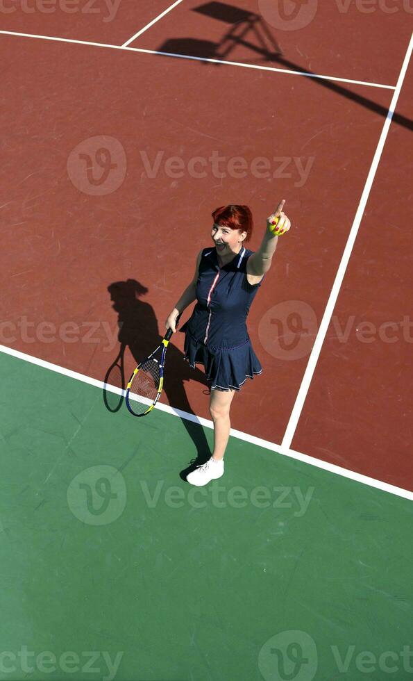 young woman play tennis game outdoor photo