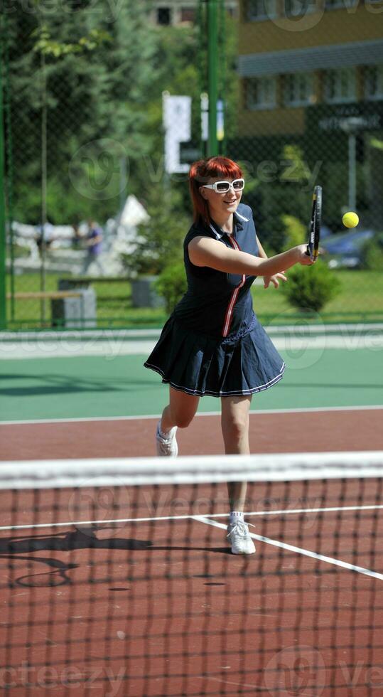 young woman play tennis game outdoor photo