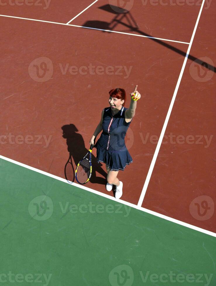 young woman play tennis game outdoor photo