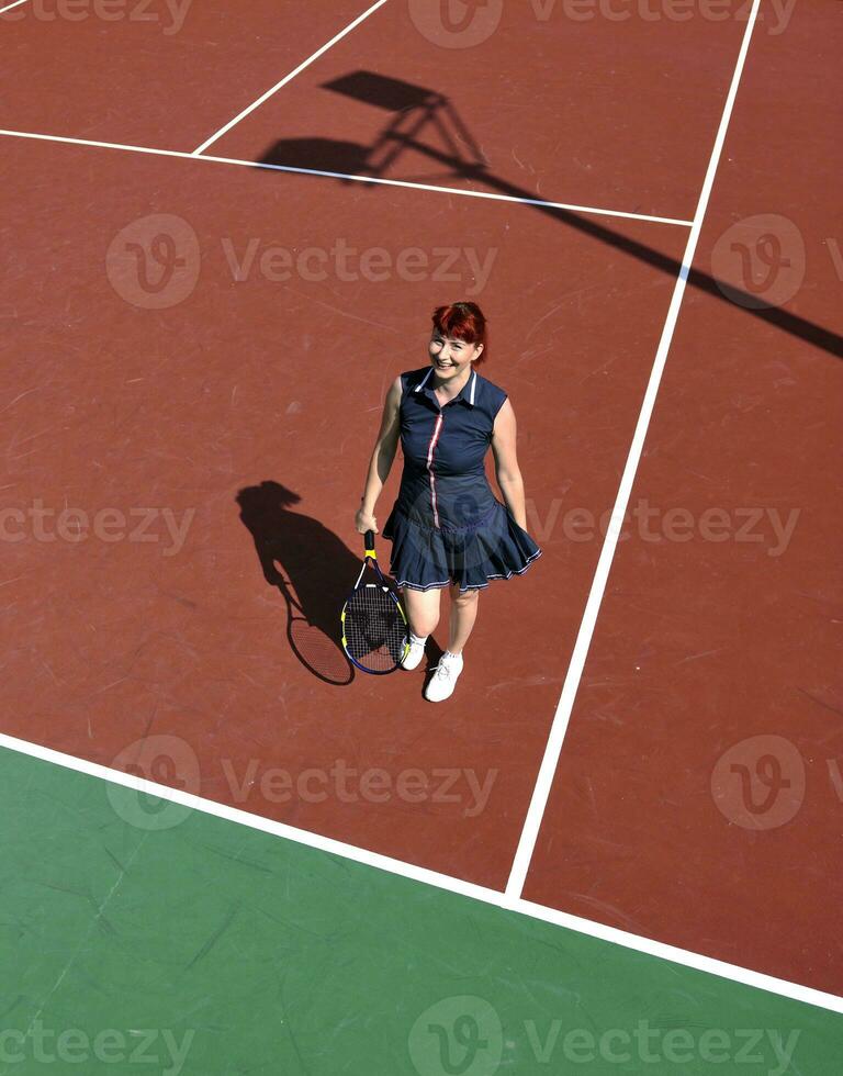 young woman play tennis game outdoor photo