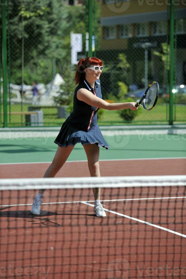 young woman play tennis game outdoor photo