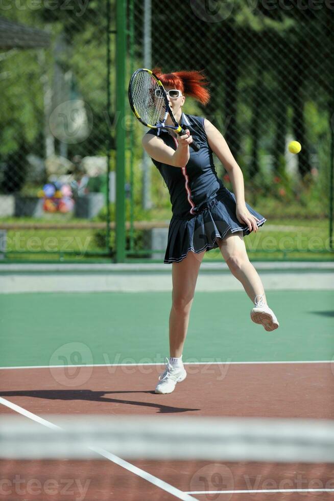 young woman play tennis game outdoor photo