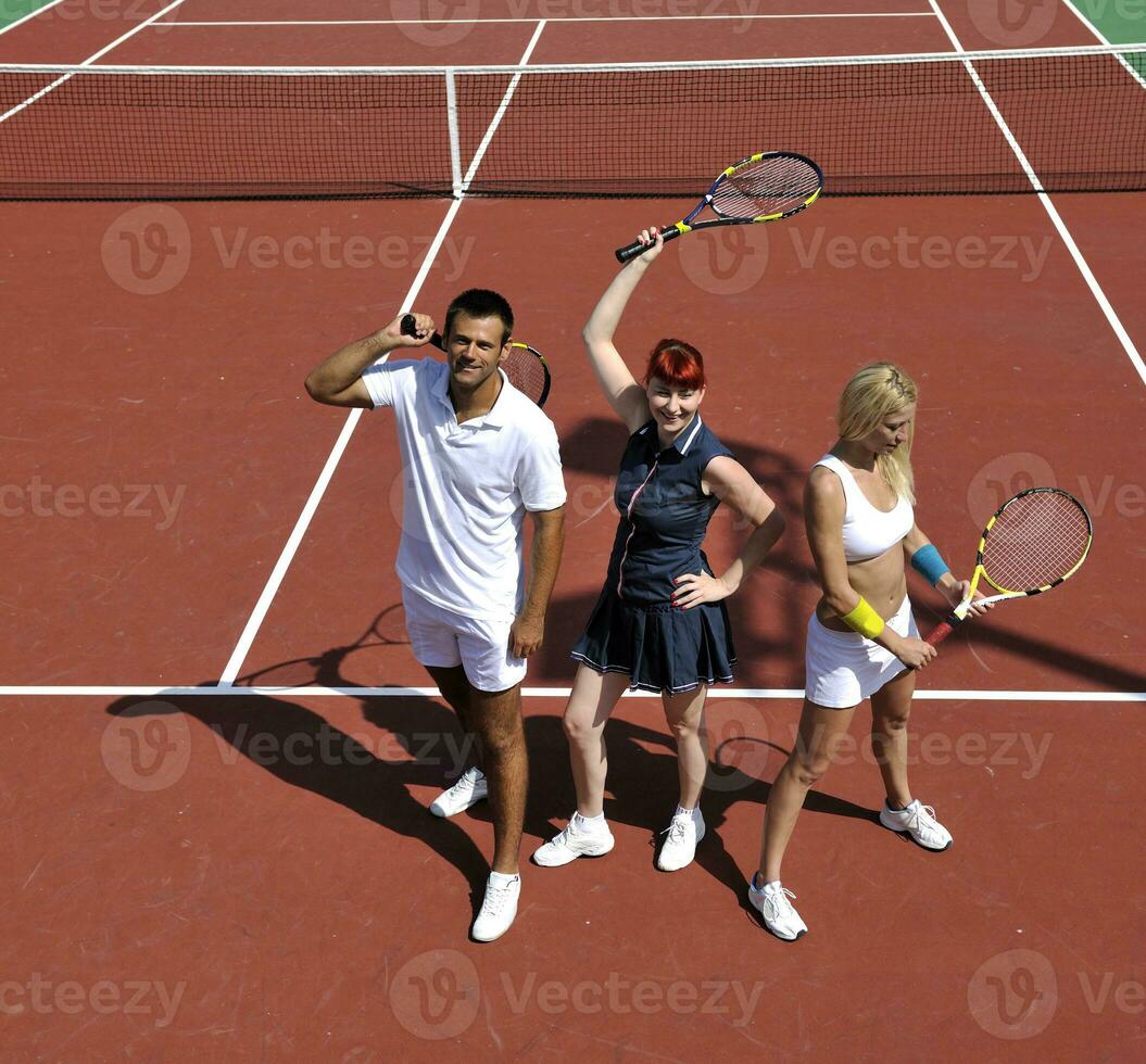 happy young couple play tennis game outdoor photo