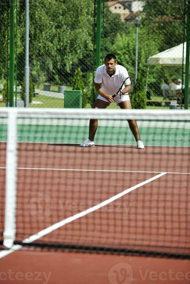 young man play tennis outdoor photo