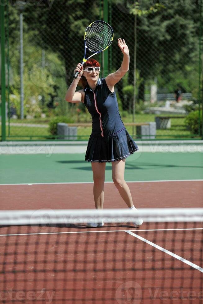 young woman play tennis game outdoor photo