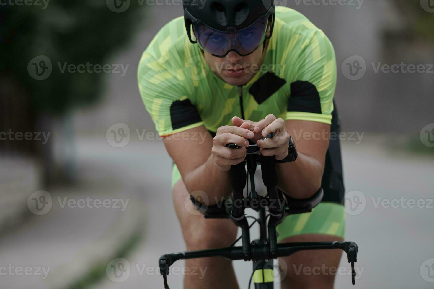 triathlon athlete riding a bike on morning training photo