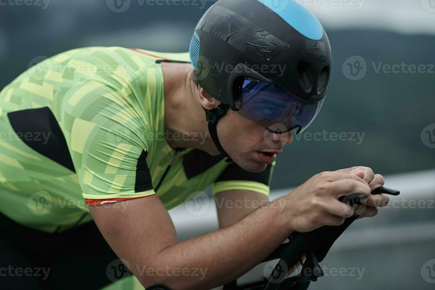 atleta de triatlón montando en bicicleta en el entrenamiento matutino foto