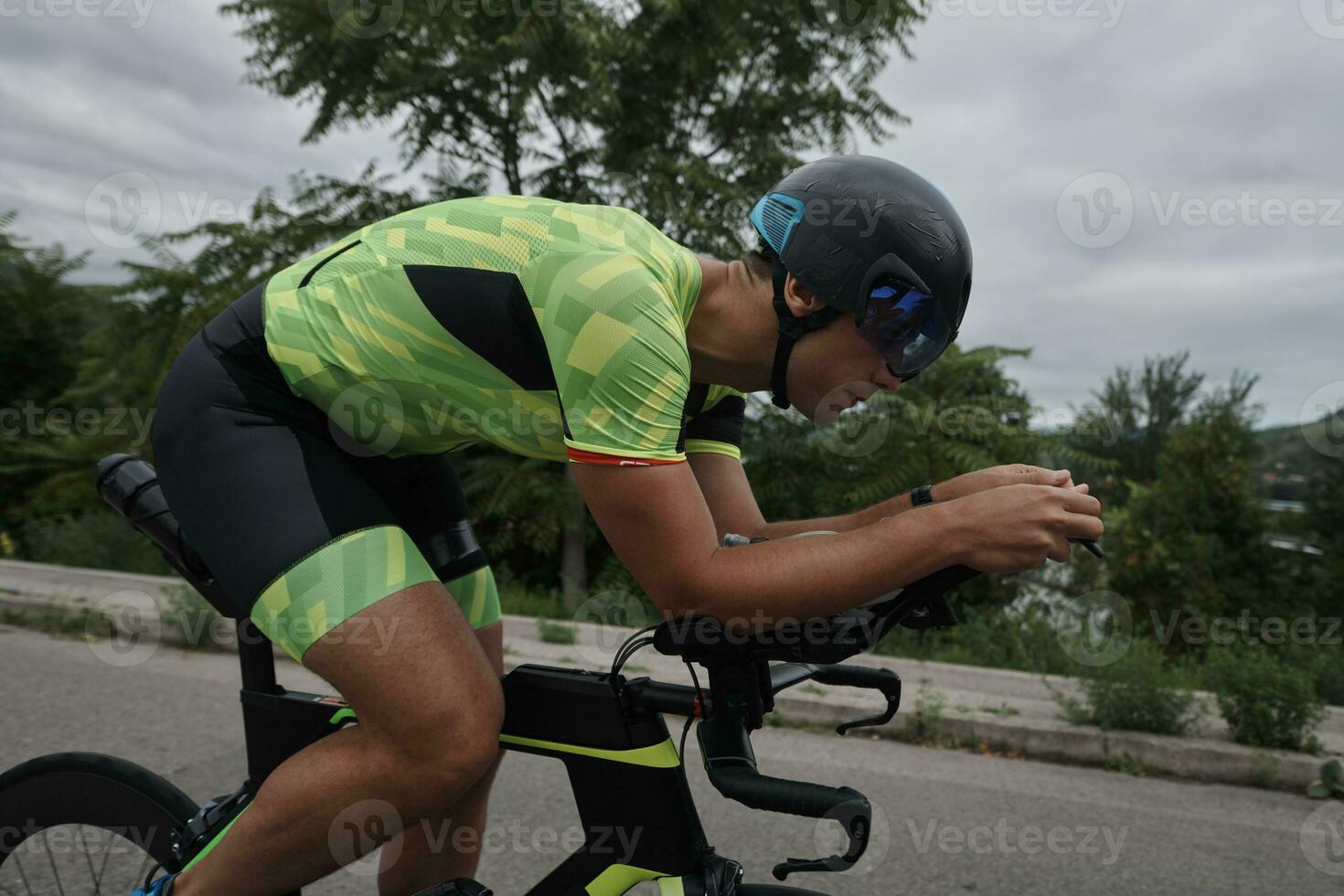 triathlon athlete riding a bike on morning training photo