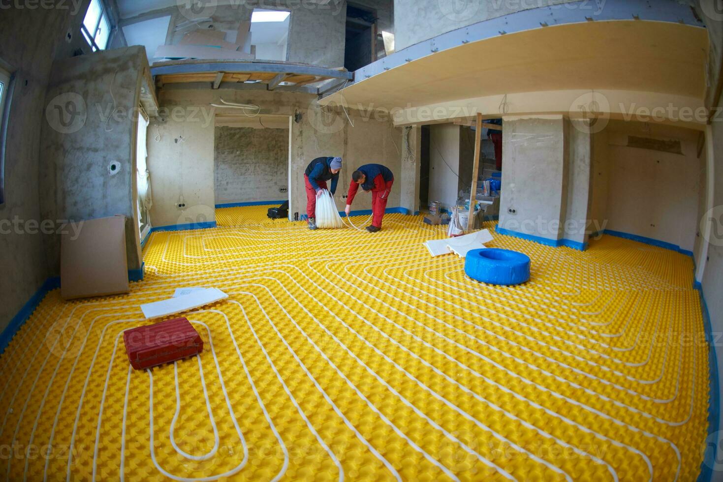 workers installing underfloor heating system photo