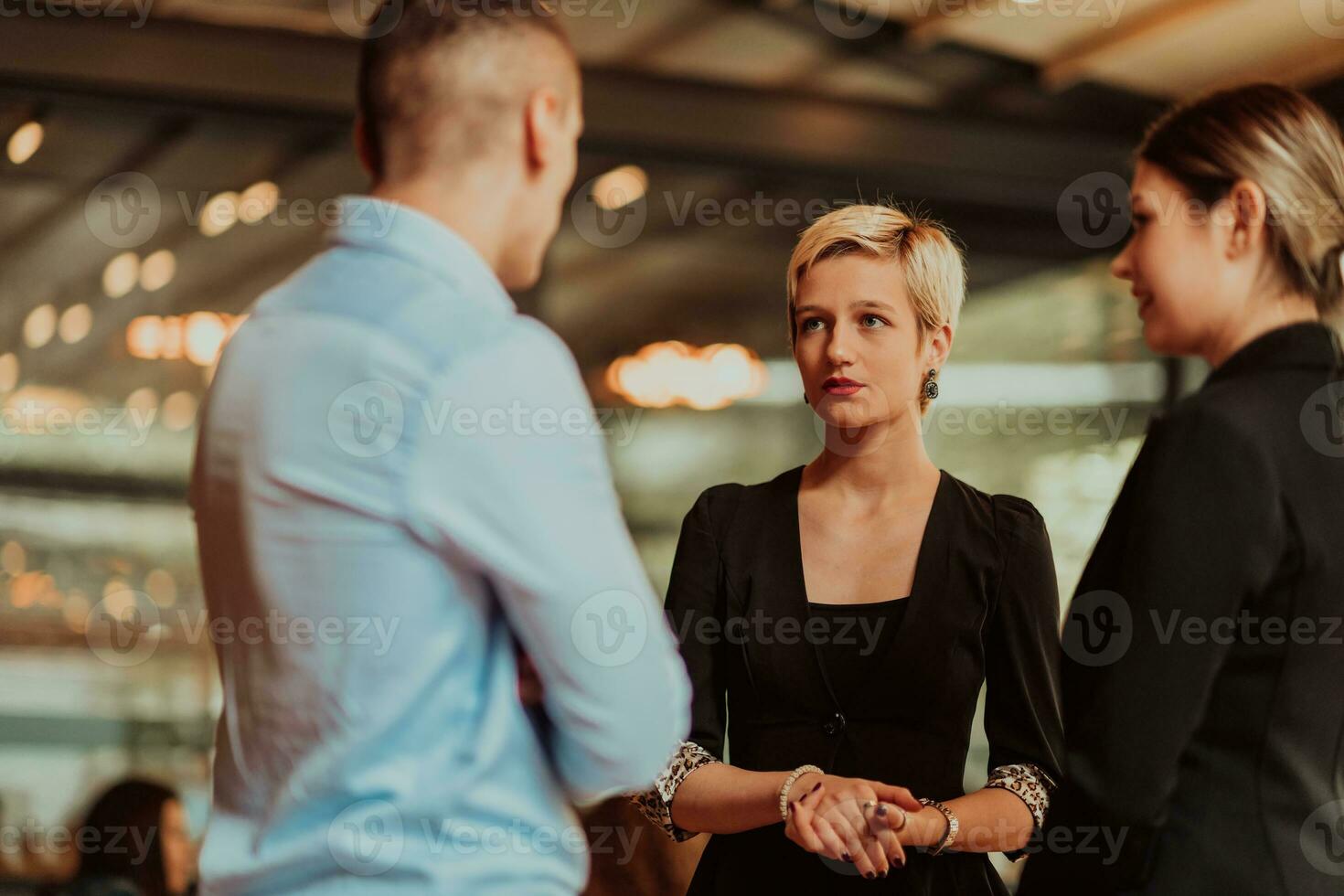 Photo of a business team of young people discussing business ideas in a modern urban environment. Selective focus