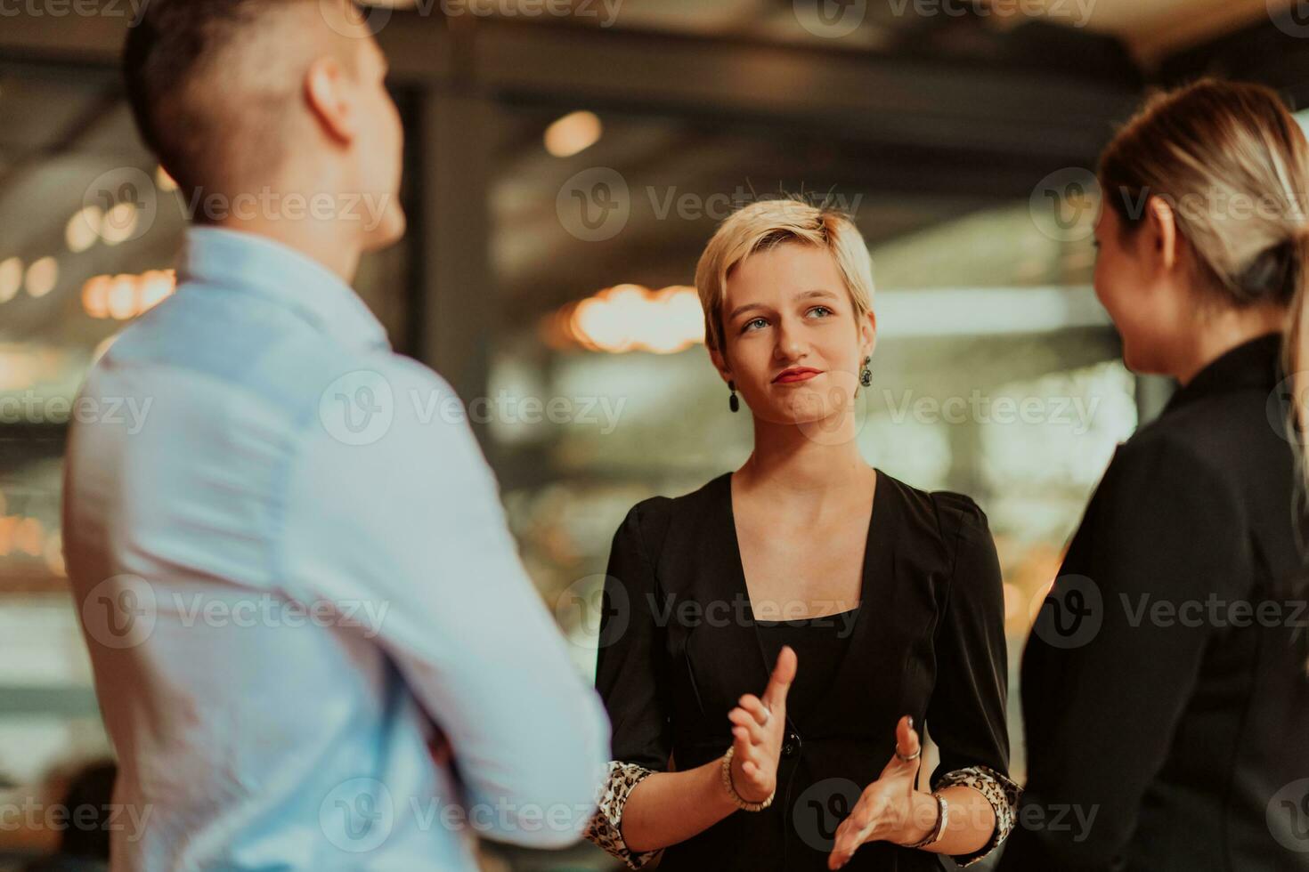 Photo of a business team of young people discussing business ideas in a modern urban environment. Selective focus