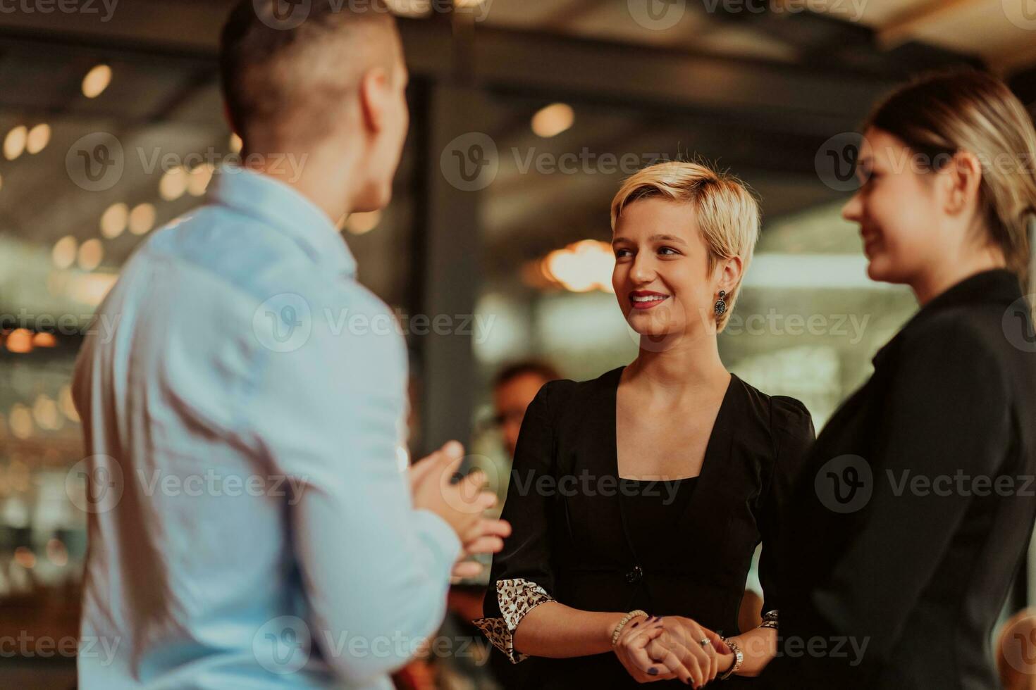 Photo of a business team of young people discussing business ideas in a modern urban environment. Selective focus