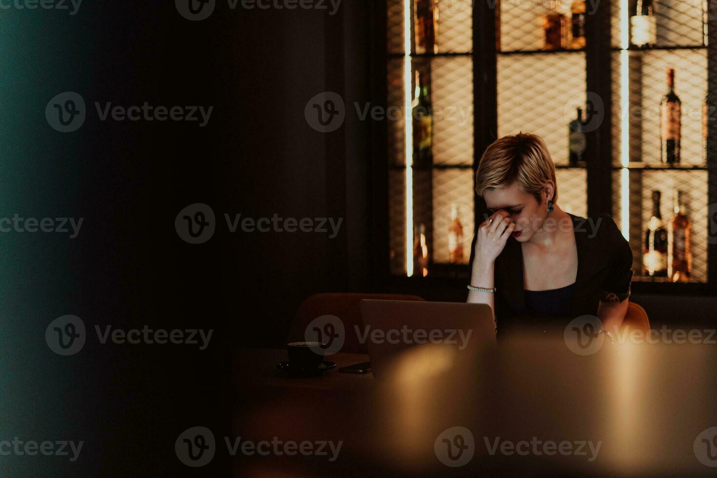 Businesswomen are stressed while working on laptop, Tired businesswoman with headache in coffee shop , feeling sick at work. Selective focus photo