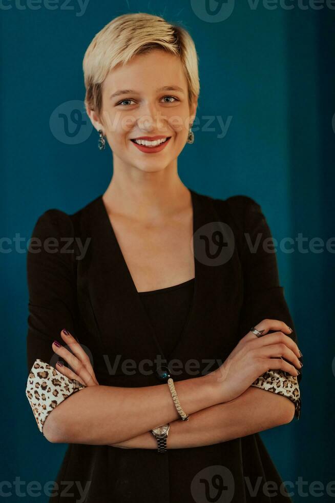 Pretty business woman, successful confidence with arms crossed on modern blue mat background. Selective focus photo