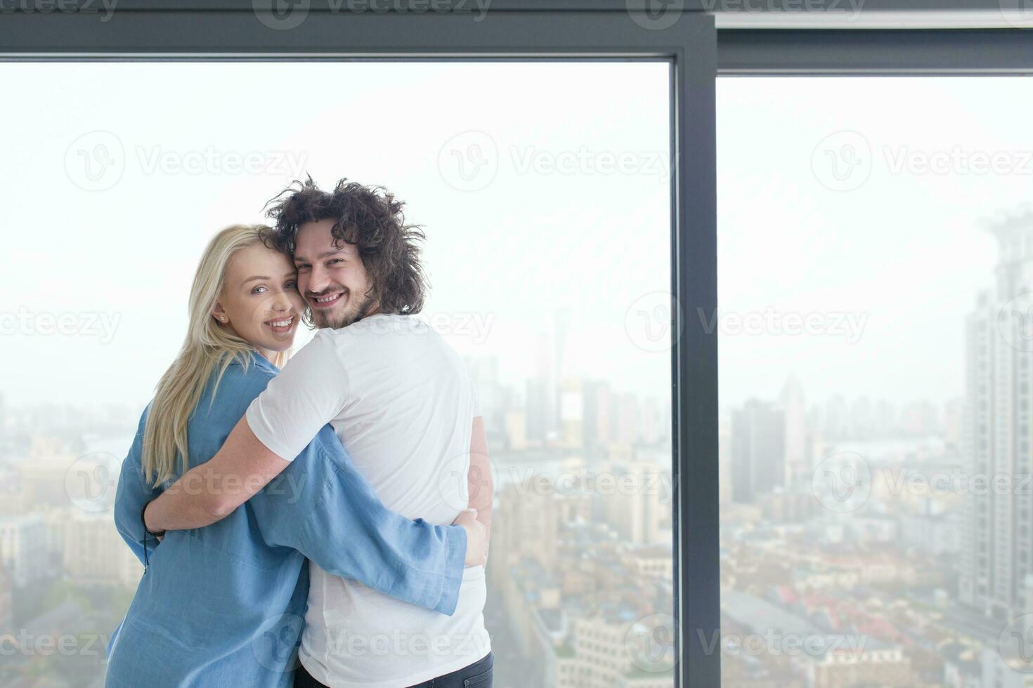 young couple enjoying morning coffee by the window photo