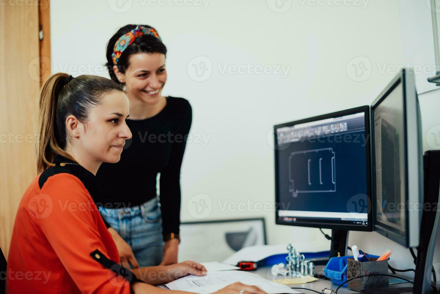 Within the heavy industry, a factory industrial engineer measures with a caliper and on a personal computer Designs a 3D model photo