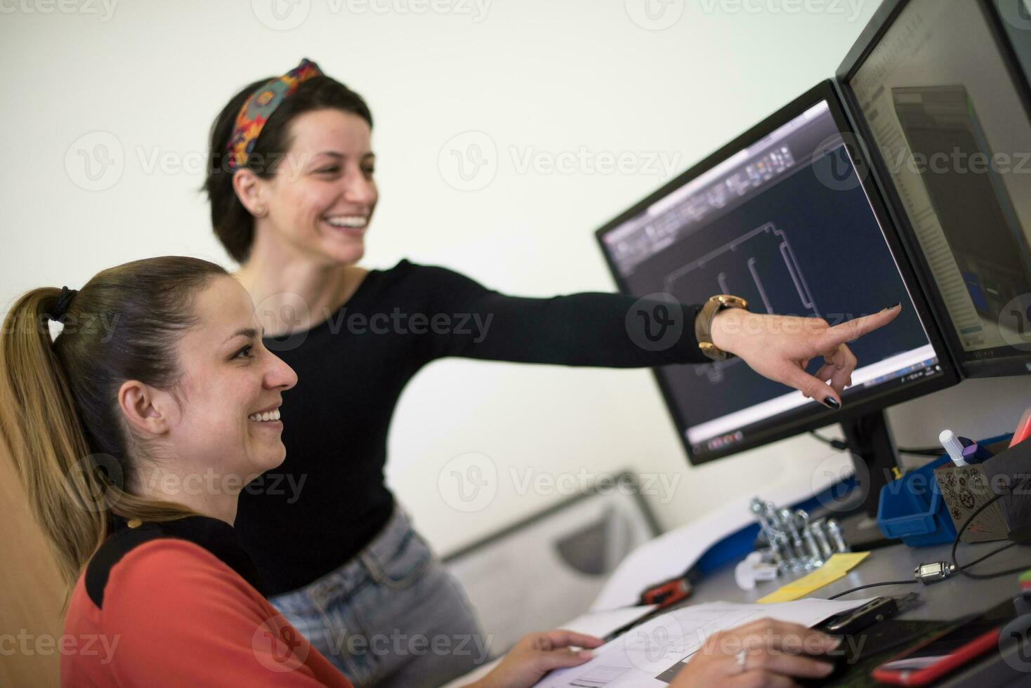 Within the heavy industry, a factory industrial engineer measures with a caliper and on a personal computer Designs a 3D model photo