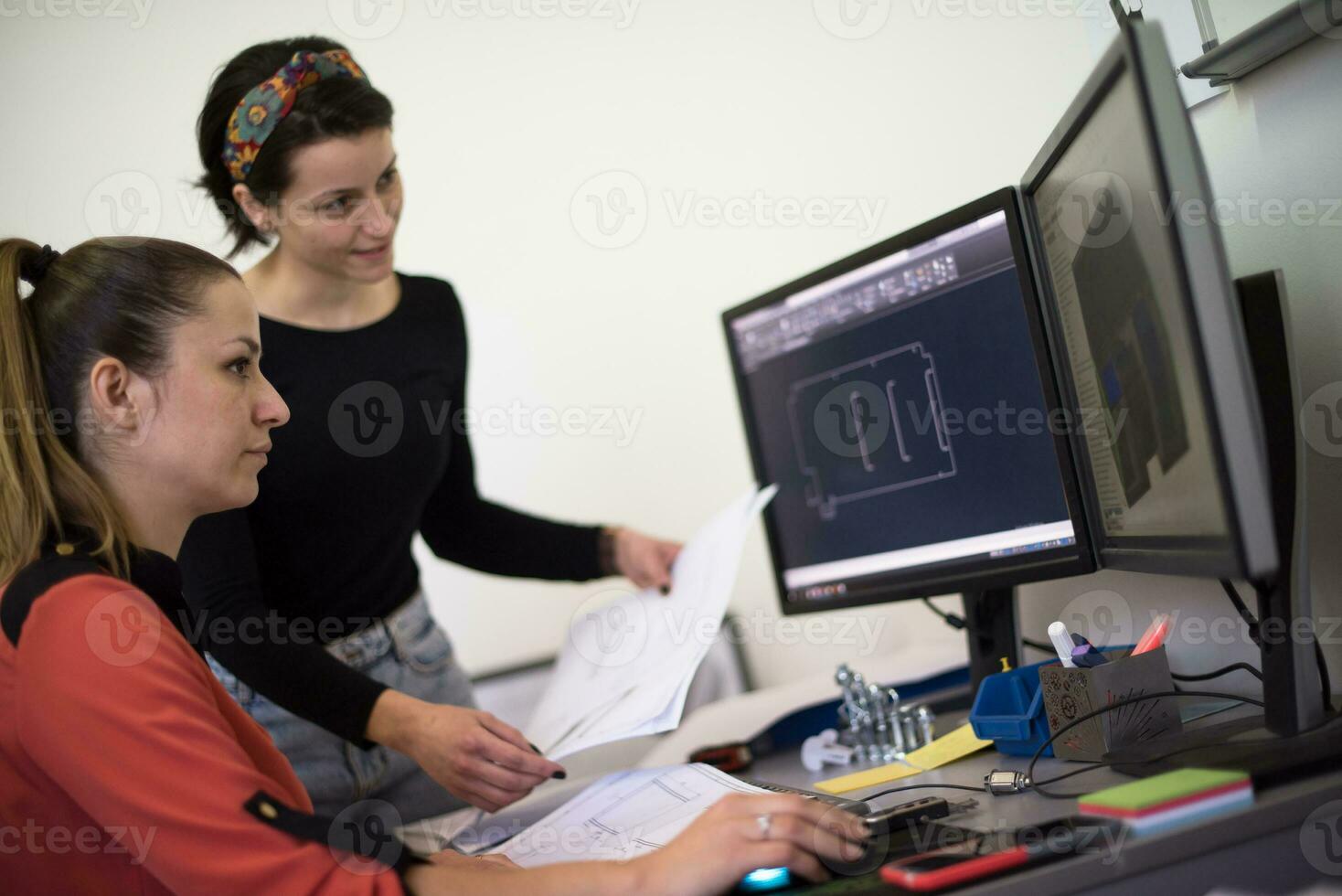 Within the heavy industry, a factory industrial engineer measures with a caliper and on a personal computer Designs a 3D model photo