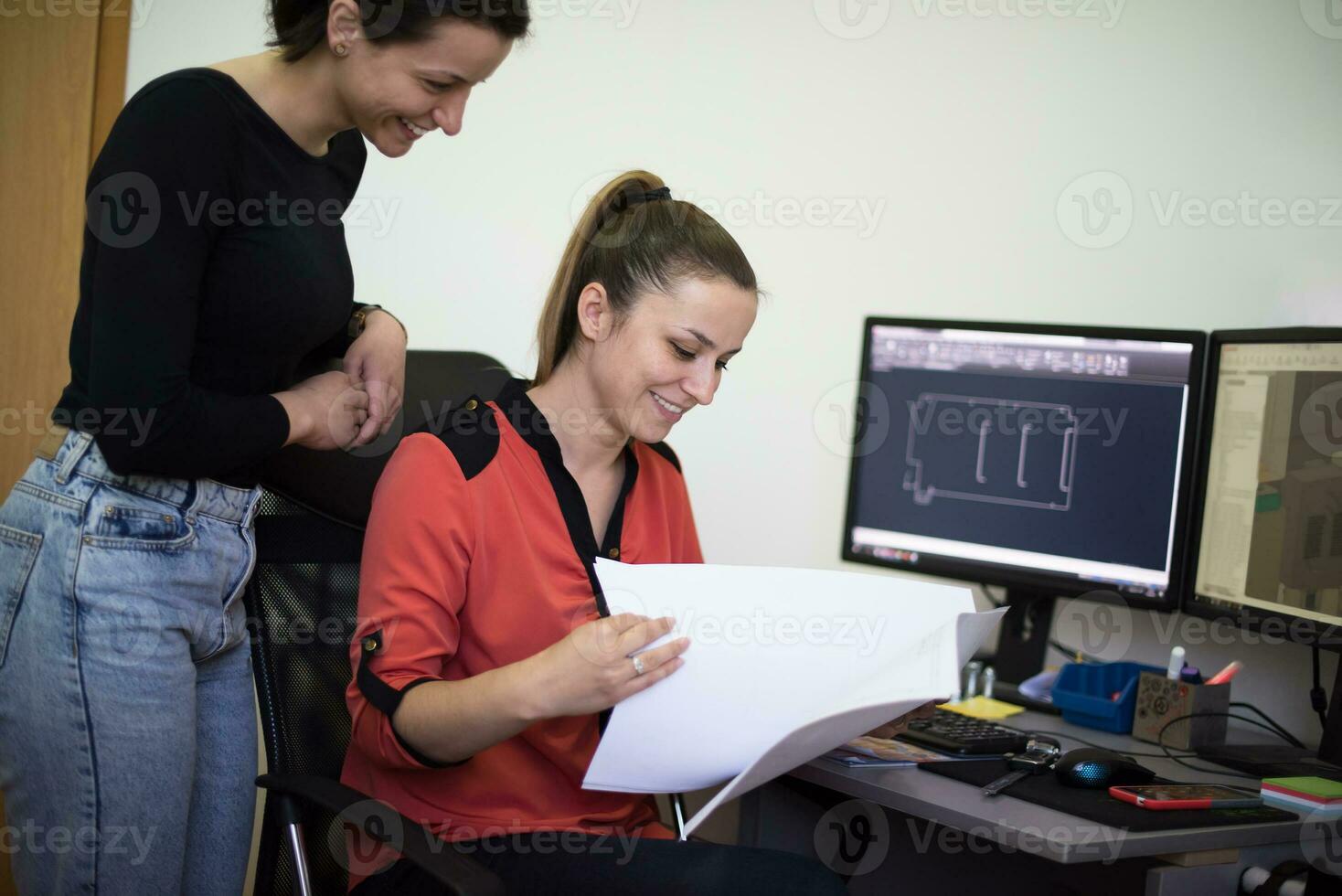Within the heavy industry, a factory industrial engineer measures with a caliper and on a personal computer Designs a 3D model photo
