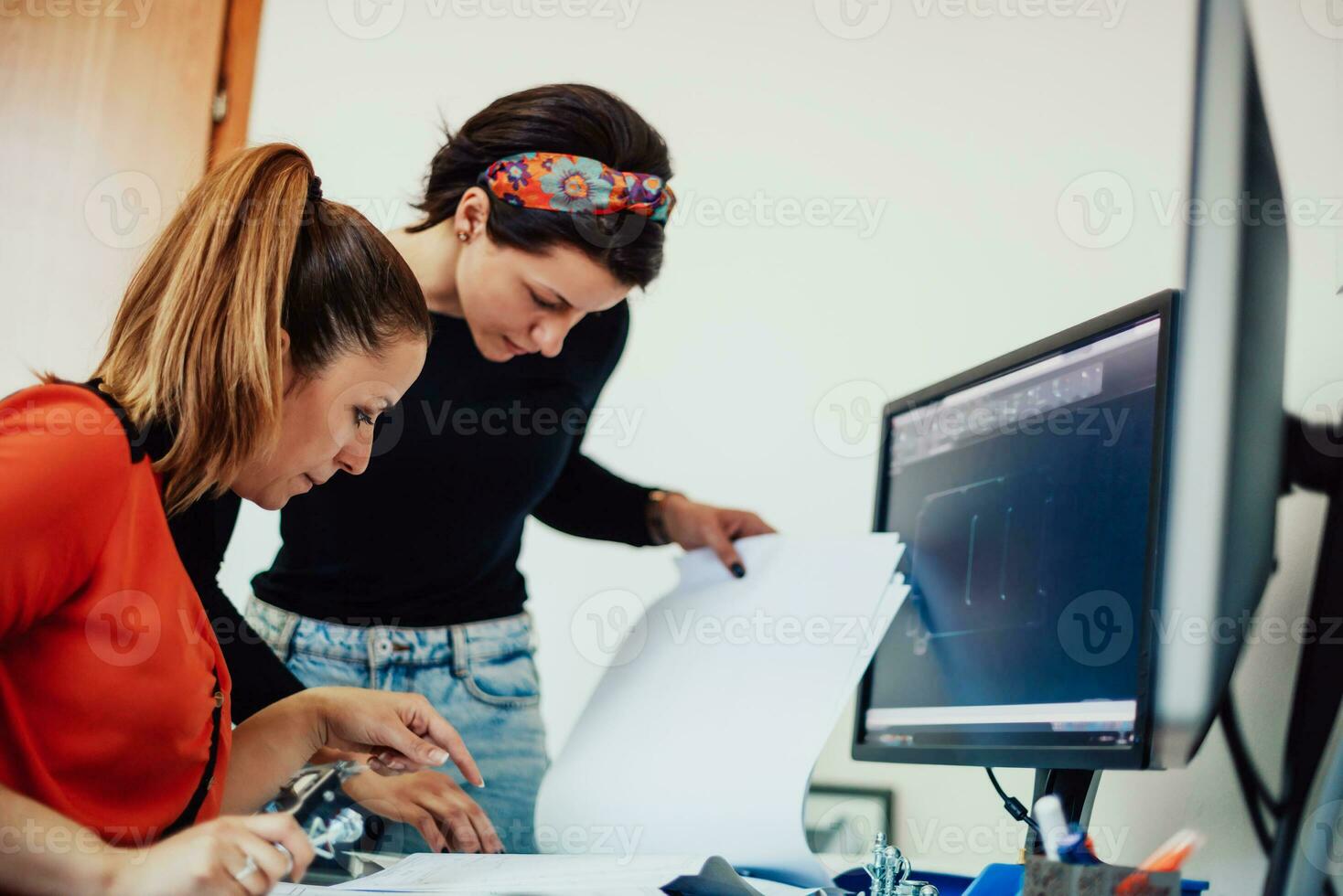 Within the heavy industry, a factory industrial engineer measures with a caliper and on a personal computer Designs a 3D model photo