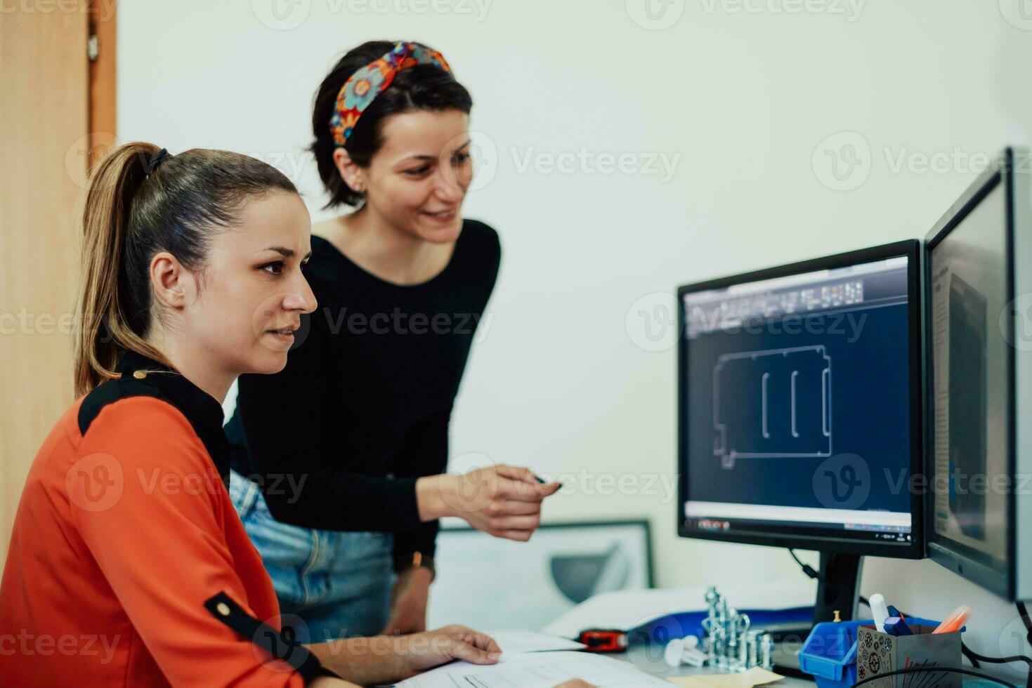 Within the heavy industry, a factory industrial engineer measures with a caliper and on a personal computer Designs a 3D model photo