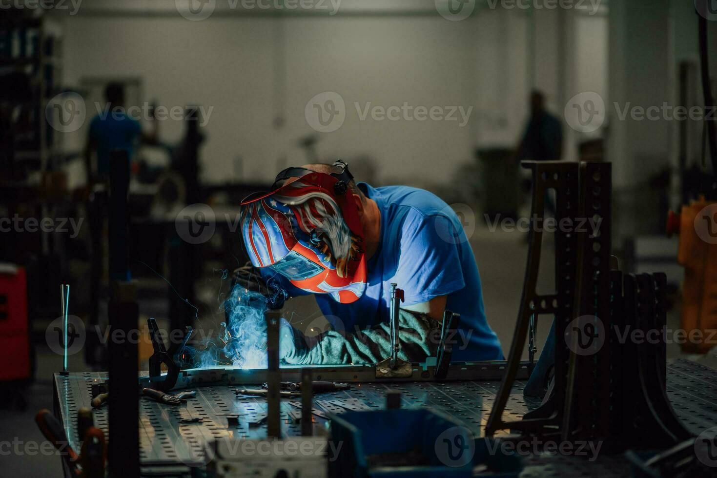 Professional Heavy Industry Welder Working Inside factory, Wears Helmet and Starts Welding. Selective Focus photo