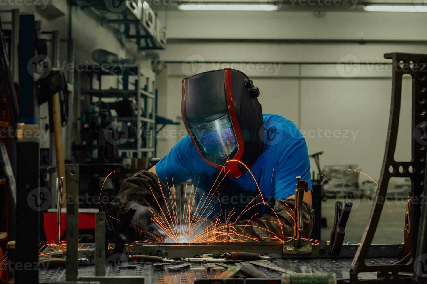 Professional Heavy Industry Welder Working Inside factory, Wears Helmet and Starts Welding. Selective Focus photo