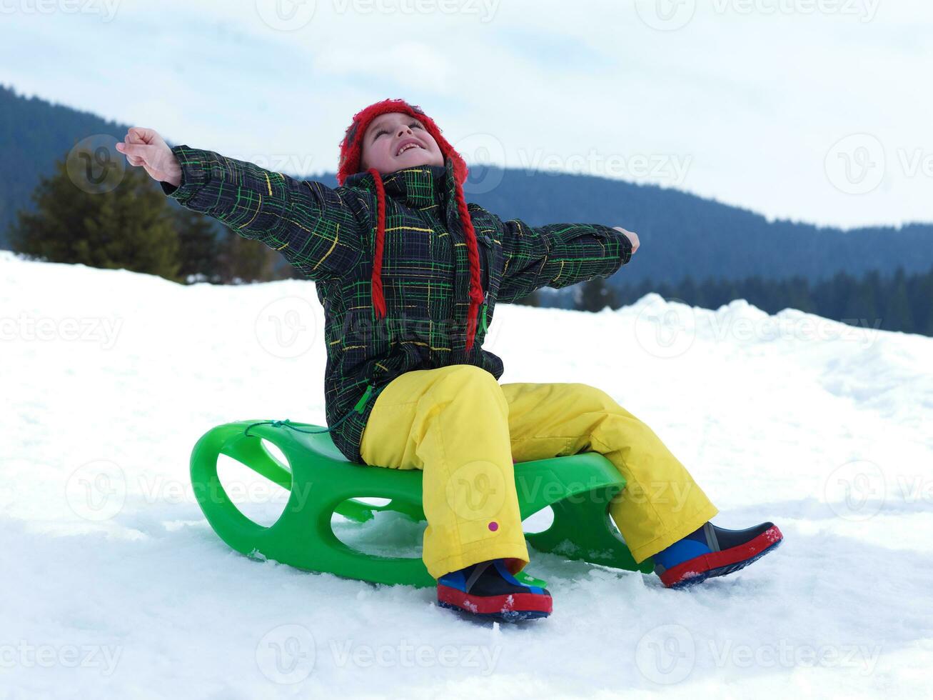 happy young boy have fun on winter vacatioin on fresh snow photo