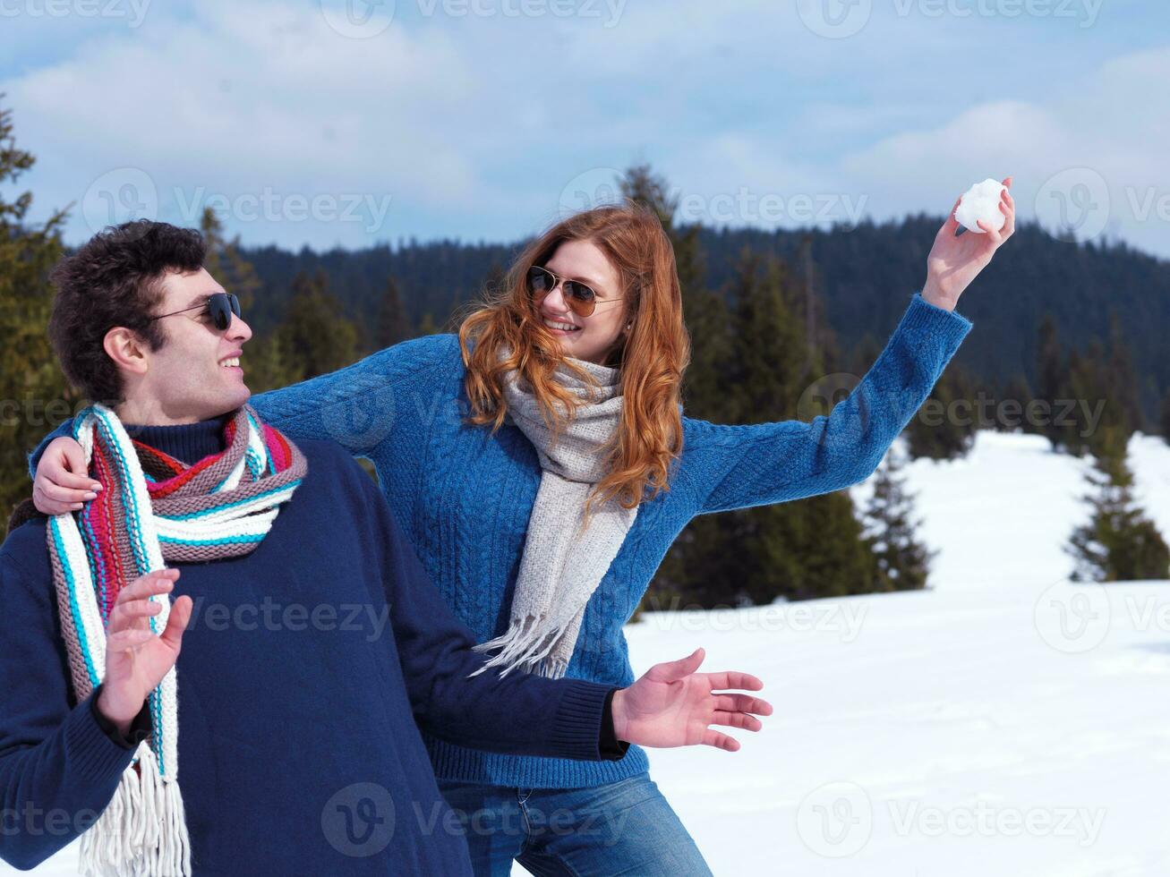 happy young couple having fun on fresh show on winter vacation photo