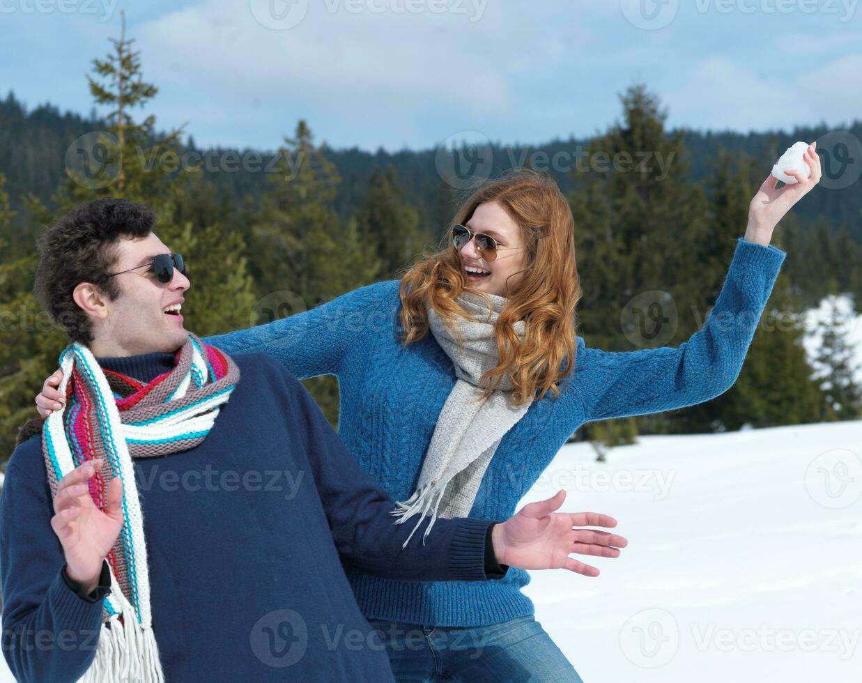 happy young couple having fun on fresh show on winter vacation photo